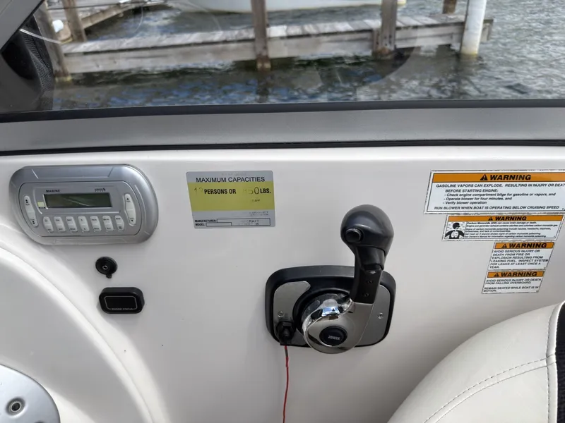 Slide: The Image of The image shows the helm of a Starcraft 2210 boat with throttle control and warning labels. - 19