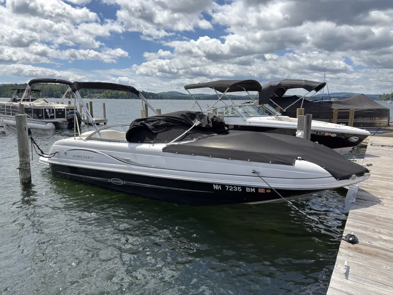Slide: The Image of A 2011 Starcraft 2210 boat is docked. It features a black cover. - 7