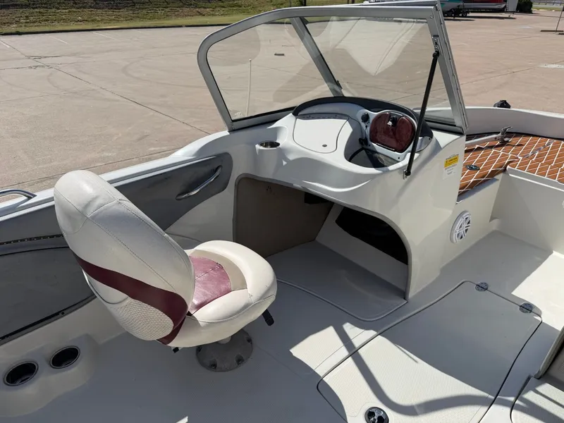 Slide: The Image of The image shows the cockpit of a 2013 Nitro 290 Sport boat with a white seat. - 11