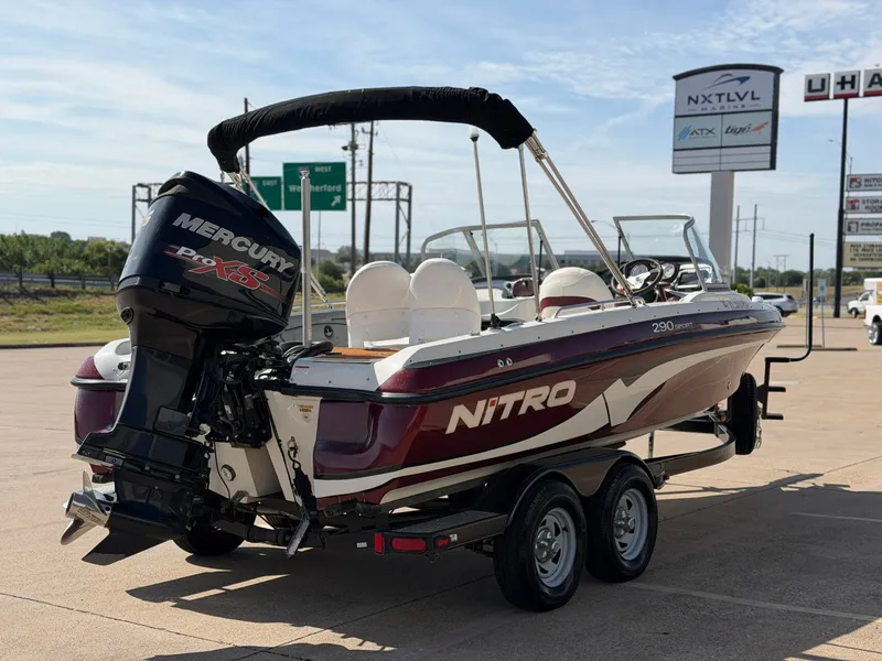 Slide: The Image of A 2013 Nitro 290 Sport boat on a trailer, featuring a Mercury outboard motor. - 4