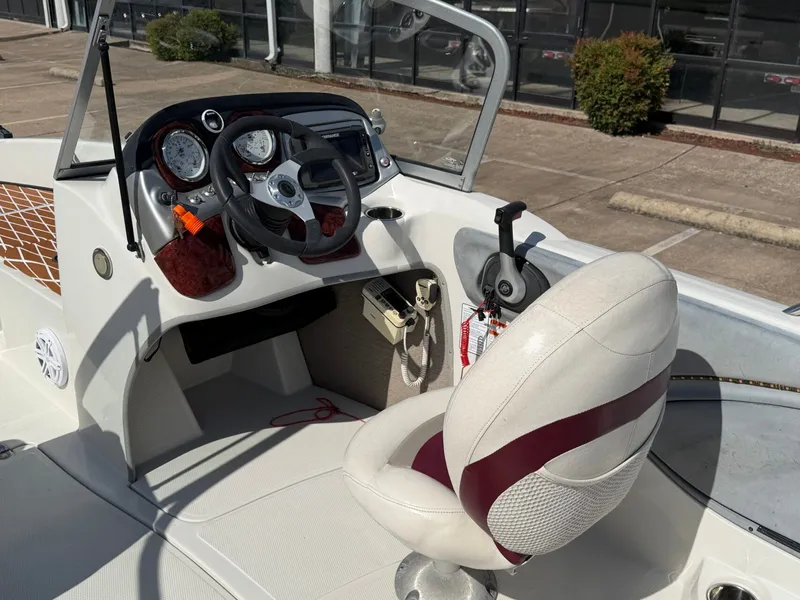Slide: The Image of The image shows the cockpit of a 2013 Nitro 290 Sport boat with a white seat and control console. - 9