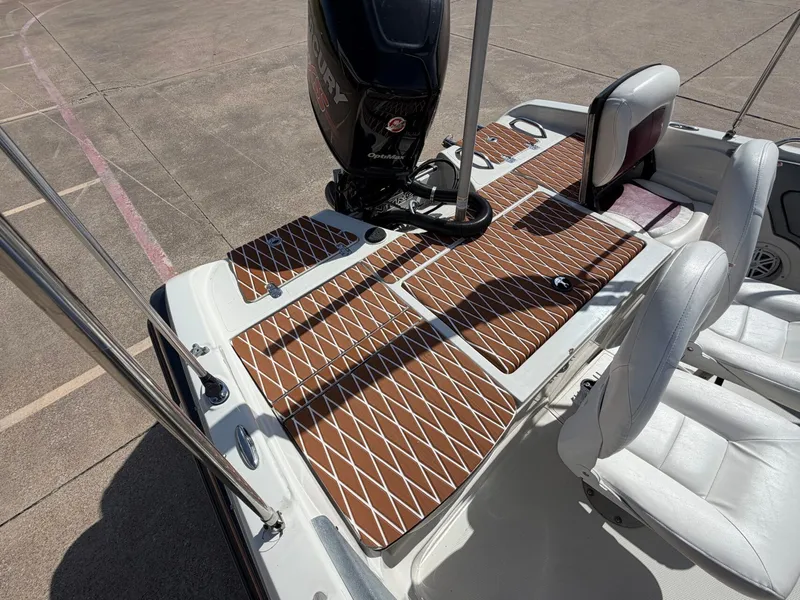 Slide: The Image of The image shows the deck of a 2013 Nitro 290 Sport boat with brown padding. - 13