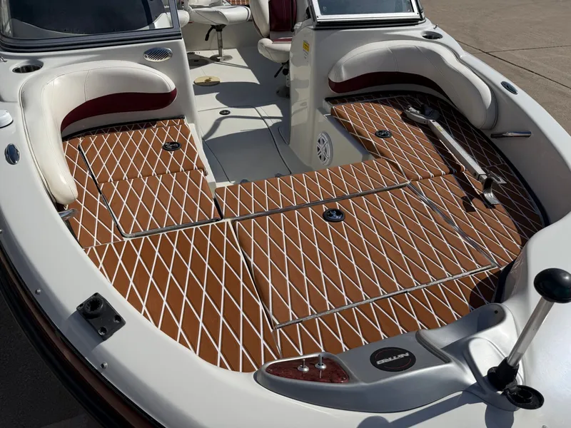 Slide: The Image of The image shows the deck of a 2013 Nitro 290 Sport boat with a brown diamond pattern. - 7