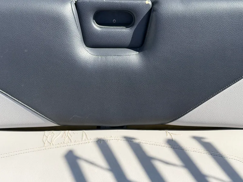 Slide: The Image of Close-up of a boat seat with black and beige upholstery. - 13