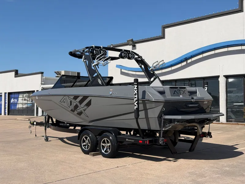 Slide: The Image of A gray 2020 ATX Surf Boat 22 Type-S on a trailer in front of a building. - 3