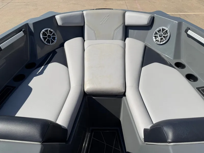 Slide: The Image of The image shows the bow area of a 2020 ATX Surf Boats 22 Type-S with gray upholstery. - 14