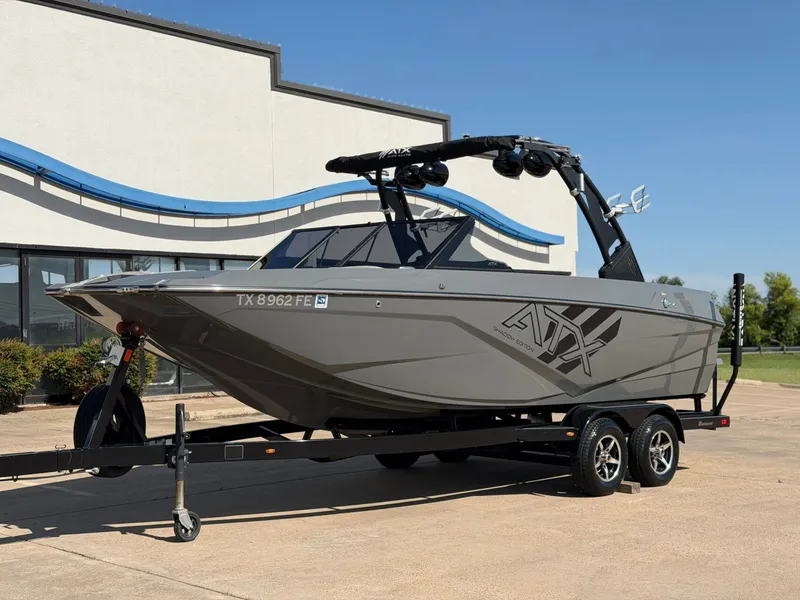 Slide: The Image of A gray 2020 ATX Surf Boat 22 Type-S on a trailer in front of a building. - 2