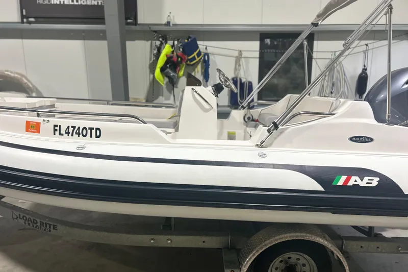 Slide: The Image of 2022 AB Inflatables Nautilus 17 DLX boat on trailer in indoor storage. - 9