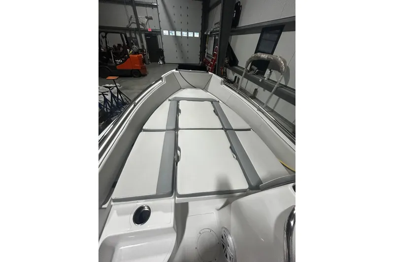 Slide: The Image of 2022 AB Inflatables Nautilus 17 DLX boat interior with cushioned seating in a garage. - 11