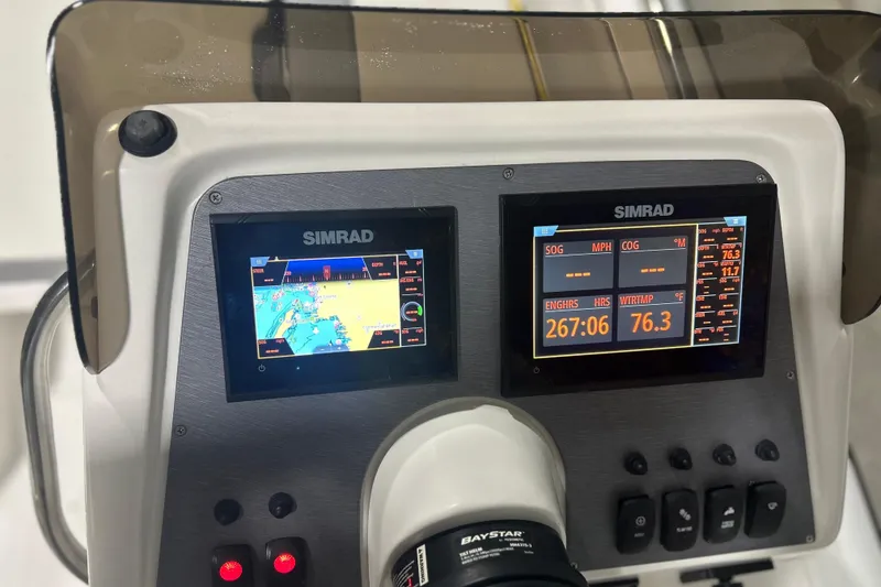 Slide: The Image of The image shows the dashboard of an AB Inflatables Nautilus 17 DLX with two Simrad screens. - 16