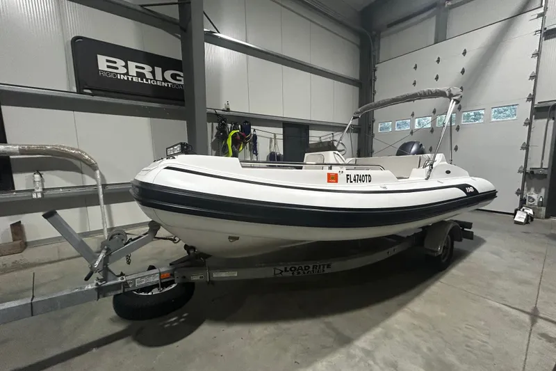 Slide: The Image of 2022 AB Inflatables Nautilus 17 DLX boat on trailer in indoor storage. - 1