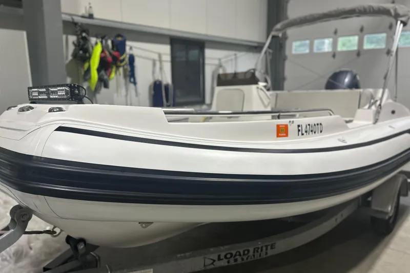 Slide: The Image of 2022 AB Inflatables Nautilus 17 DLX boat on trailer in garage setting. - 8