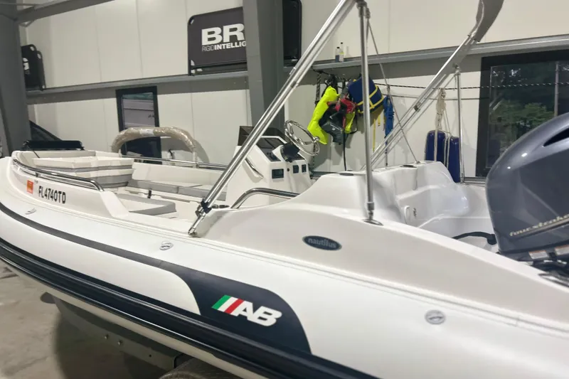 Slide: The Image of 2022 AB Inflatables Nautilus 17 DLX boat in showroom, featuring sleek design and modern equipment. - 10