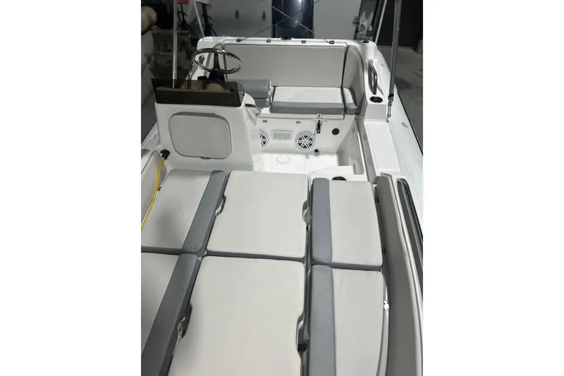 Slide: The Image of 2022 AB Inflatables Nautilus 17 DLX boat interior with cushioned seating and steering console. - 12