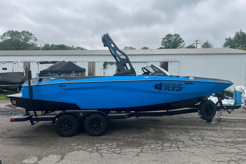 Slide: The Image of 2026 Axis A225 boat in vibrant blue on a trailer, parked outdoors. - 9
