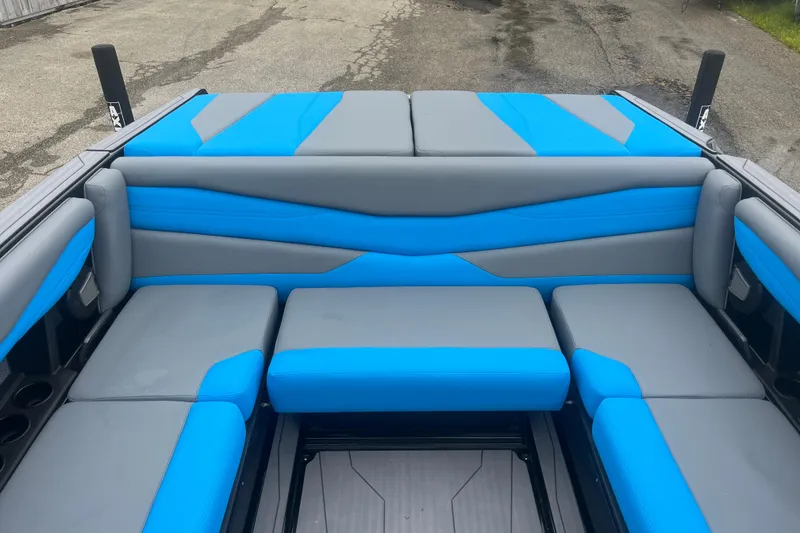 Slide: The Image of 2026 Axis A225 boat interior with blue and gray seating, showcasing modern design. - 4