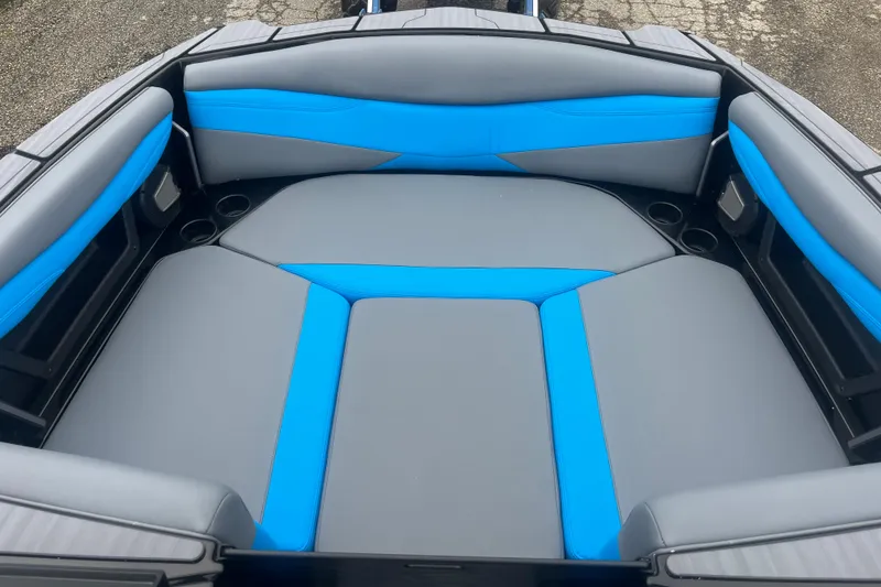 Slide: The Image of 2026 Axis A225 boat interior with blue and gray cushioned seating. - 1