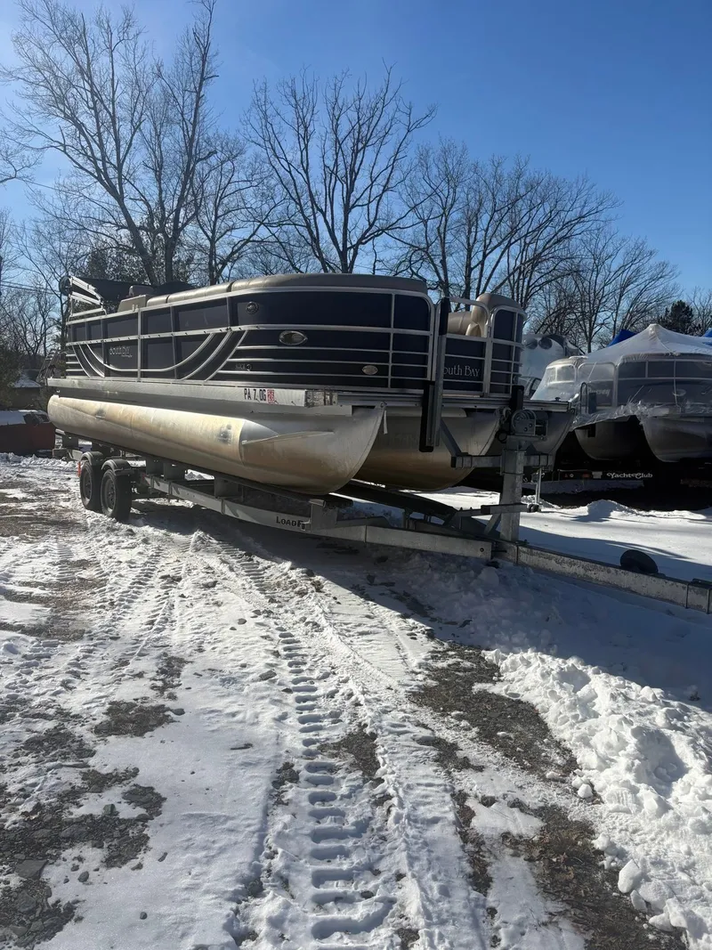 Slide: The Image of A 2008 South Bay 922CR pontoon boat is on a trailer in the snow. - 10