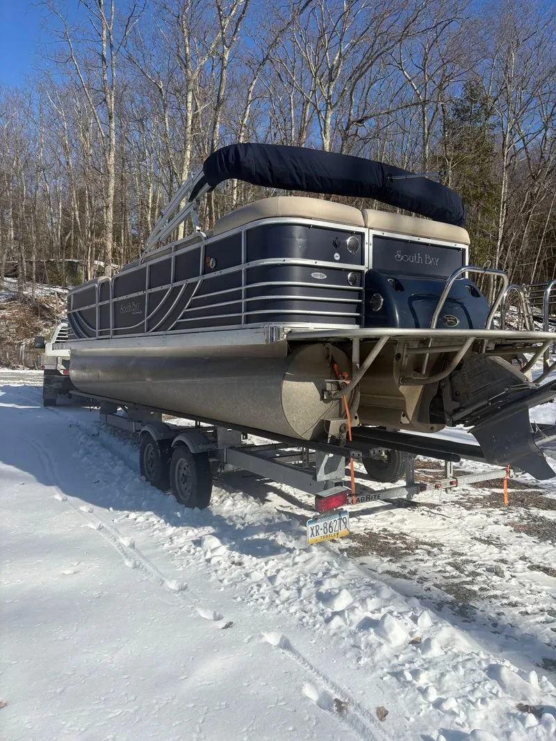 Slide: The Image of A 2008 South Bay 922CR pontoon boat on a trailer in the snow. - 7