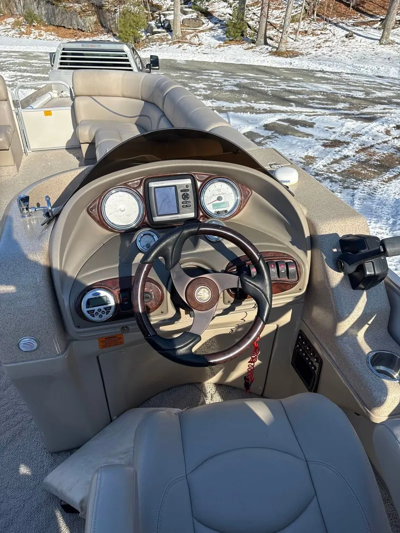 Slide: The Image of The image shows the helm of a 2008 South Bay 922CR boat with beige upholstery. - 4