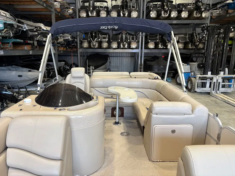 Slide: The Image of The image shows a 2008 South Bay 922CR pontoon boat with beige seating and a blue canopy. - 3