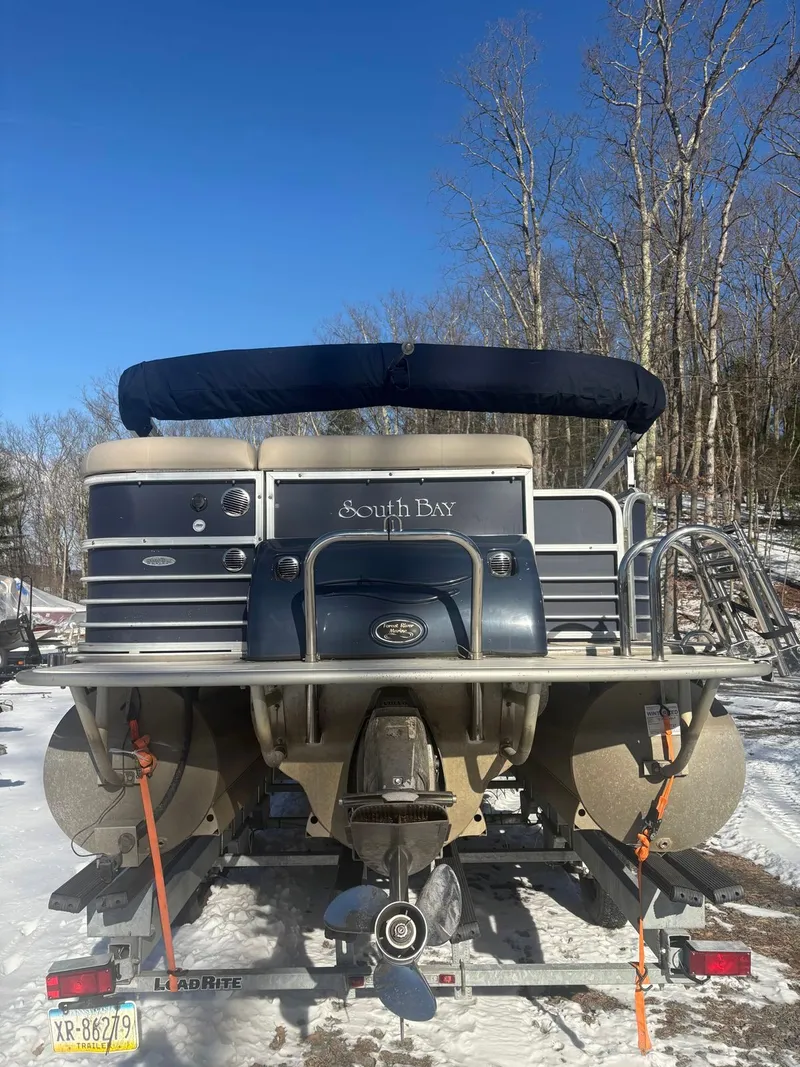 Slide: The Image of A 2008 South Bay 922CR pontoon boat is on a trailer in the snow. - 9