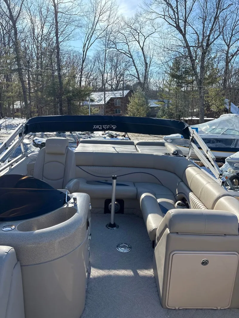 Slide: The Image of The image shows a 2008 South Bay 922CR pontoon boat with gray seating and a blue canopy. - 6