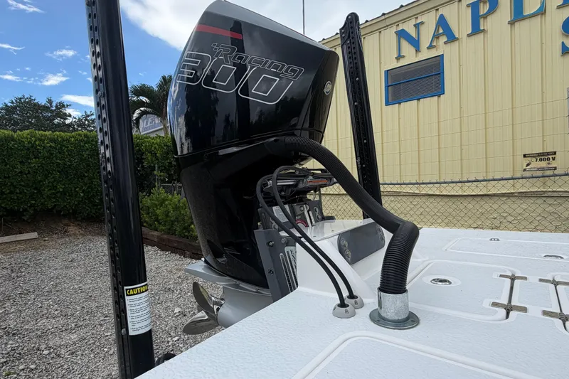 Slide: The Image of 2022 SCB S22 boat with Racing 300 engine, parked near Naples building. - 25