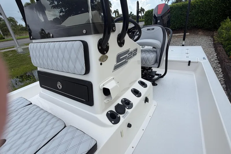 Slide: The Image of 2022 SCB S22 boat interior with cushioned seating and steering console. - 19