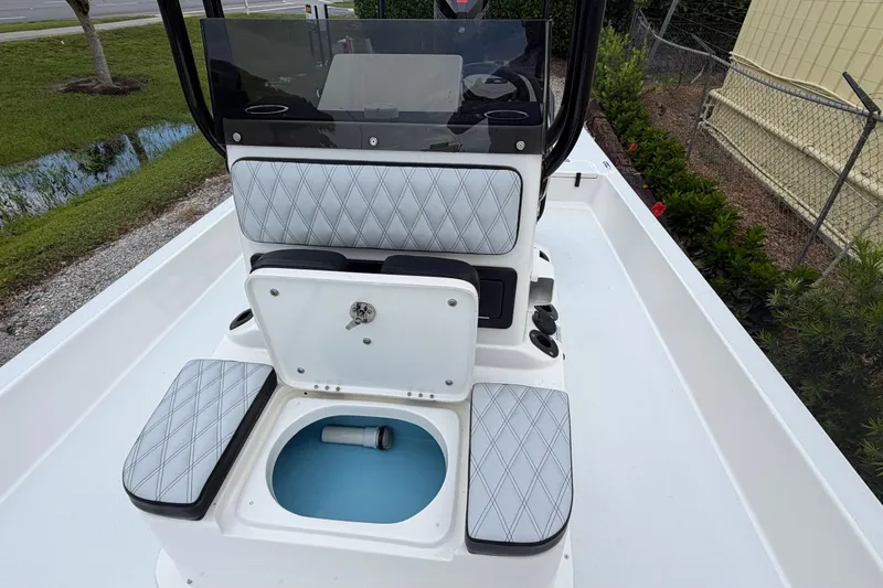 Slide: The Image of 2022 SCB S22 boat interior with cushioned seating and storage compartment. - 18