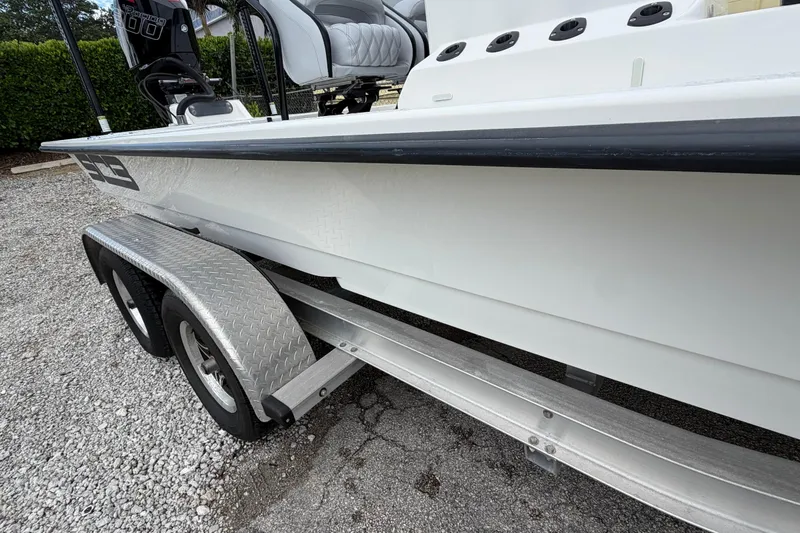 Slide: The Image of 2022 SCB S22 boat on trailer, featuring sleek design and dual axle wheels. - 7