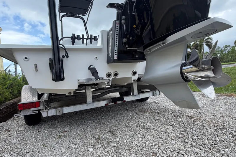 Slide: The Image of 2022 SCB S22 boat on trailer, showcasing powerful outboard motor and propeller. - 6