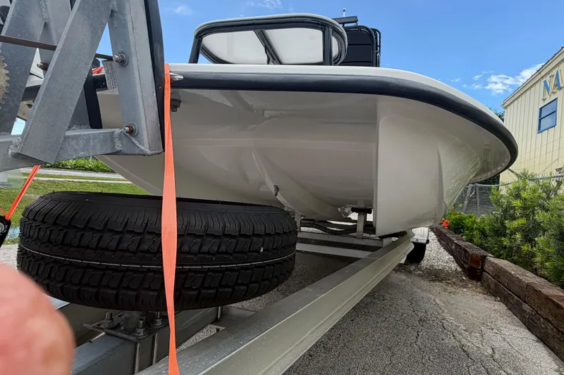 Slide: The Image of 2022 SCB S22 boat on trailer with spare tire, parked outdoors. - 8