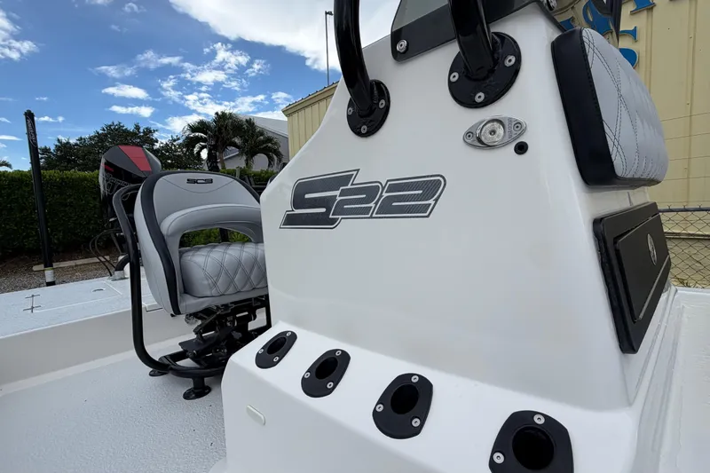 Slide: The Image of 2022 SCB S22 boat console with seating, rod holders, and sleek design under a blue sky. - 13