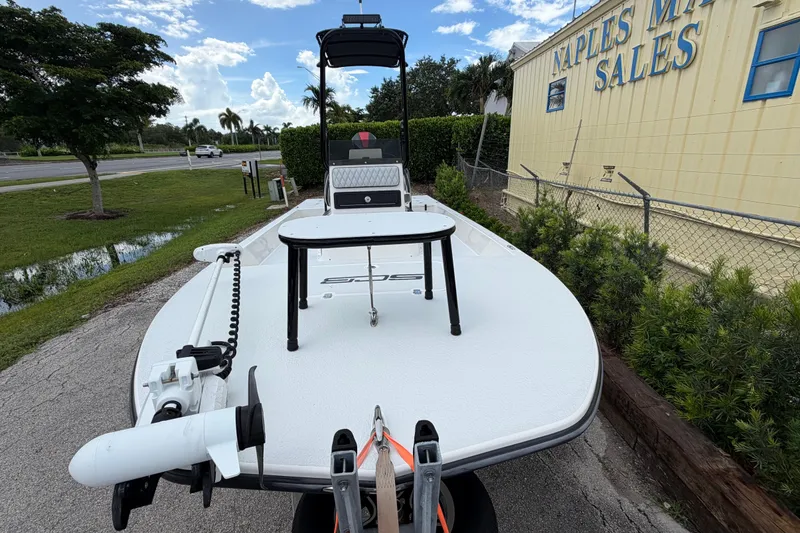 Slide: The Image of 2022 SCB S22 boat displayed at Naples Marine Sales under a clear blue sky. - 16