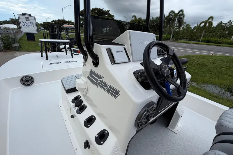 Slide: The Image of 2022 SCB S22 boat at Naples Marina, featuring steering console and seating area. - 9