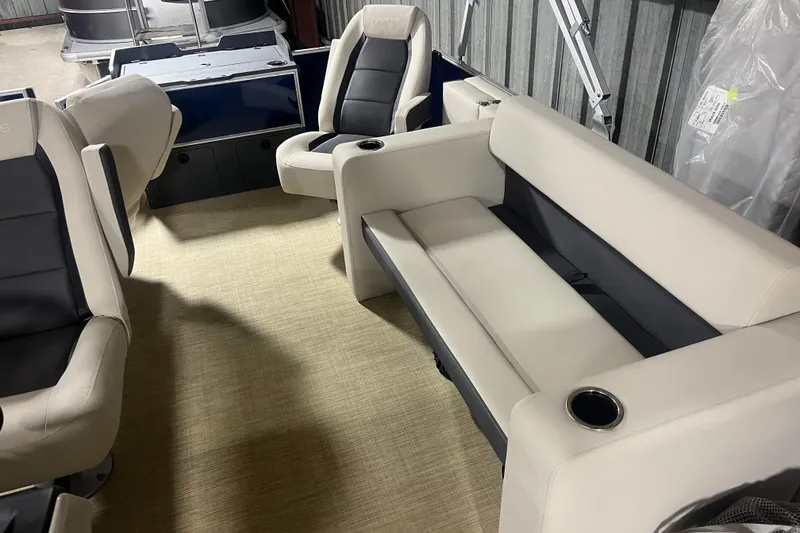 Slide: The Image of 2026 Harris Cruiser 210 FC boat interior with beige and black seating, cup holders, and modern design. - 6