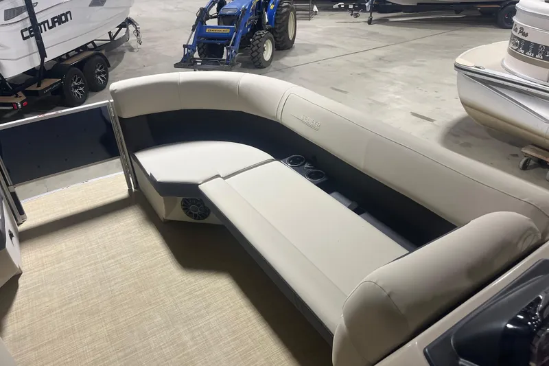 Slide: The Image of 2026 Harris Cruiser 210 FC boat interior with beige seating and cup holders. - 4