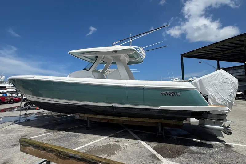 Slide: The Image of 2025 Intrepid 375 Nomad SE boat on display under clear blue sky. - 36
