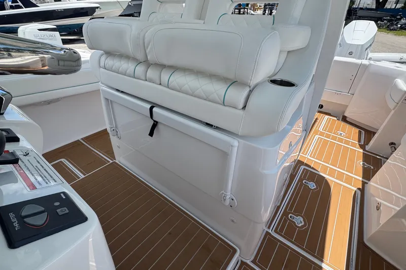 Slide: The Image of 2025 Intrepid 375 Nomad SE boat interior with white seating and teak flooring. - 25