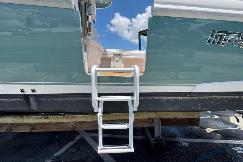 Slide: The Image of 2025 Intrepid 375 Nomad SE boat with boarding ladder and sleek design. - 18