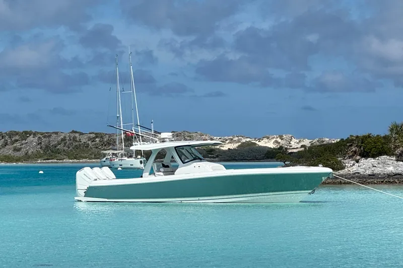 The Image of 2025 Intrepid 375 Nomad SE boat anchored in clear turquoise waters. - 0