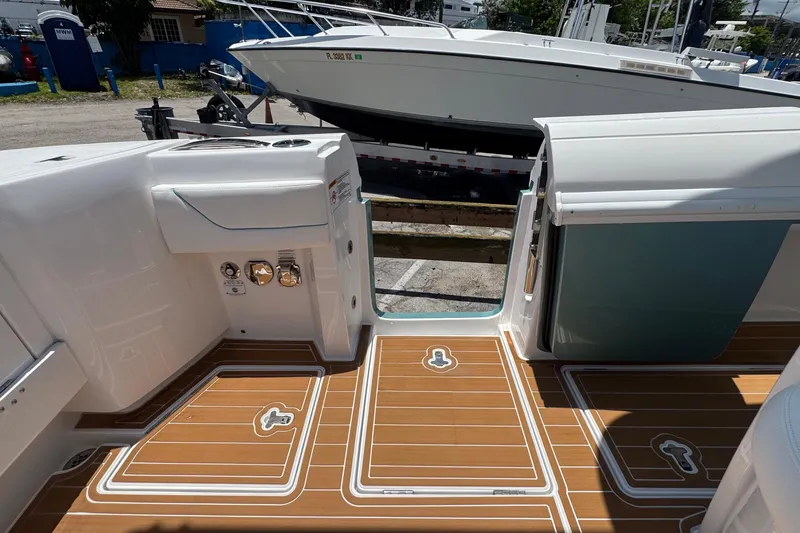 Slide: The Image of 2025 Intrepid 375 Nomad SE boat deck with teak flooring and sleek design. - 17