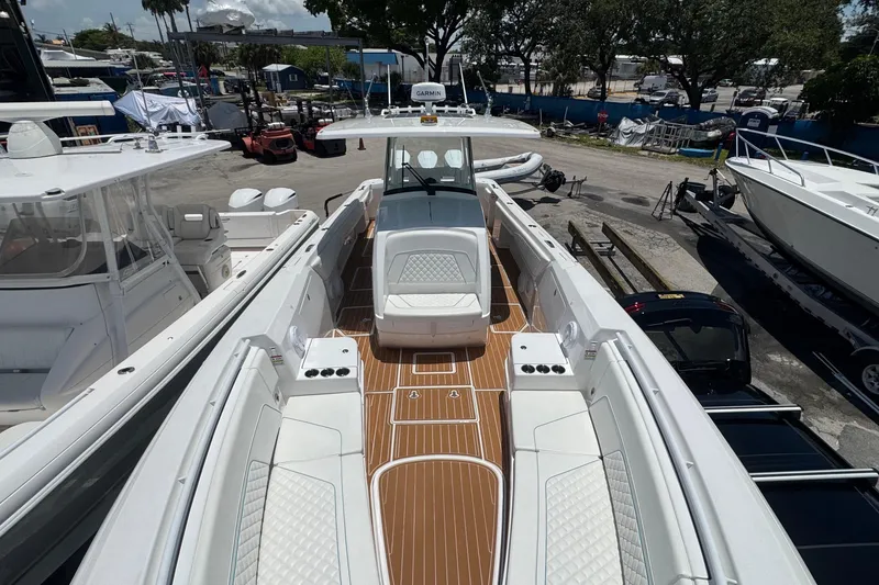 Slide: The Image of 2025 Intrepid 375 Nomad SE boat with sleek design and spacious deck layout. - 10