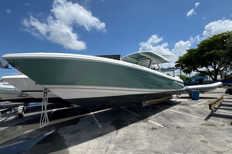 Slide: The Image of 2025 Intrepid 375 Nomad SE boat on display under a clear blue sky. - 3