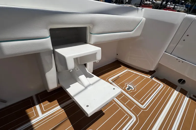 Slide: The Image of 2025 Intrepid 375 Nomad SE boat interior with fold-out step and teak-style flooring. - 16