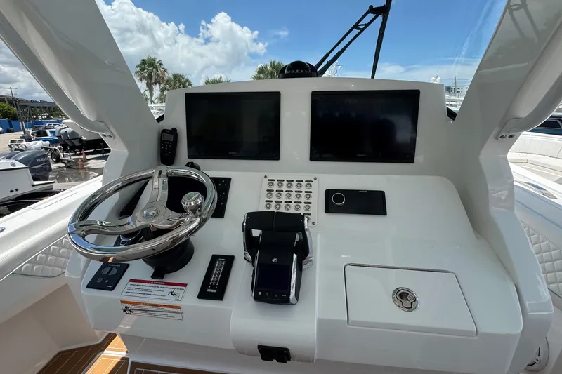 Slide: The Image of Helm of 2025 Intrepid 375 Nomad SE with modern controls and dual displays. - 23