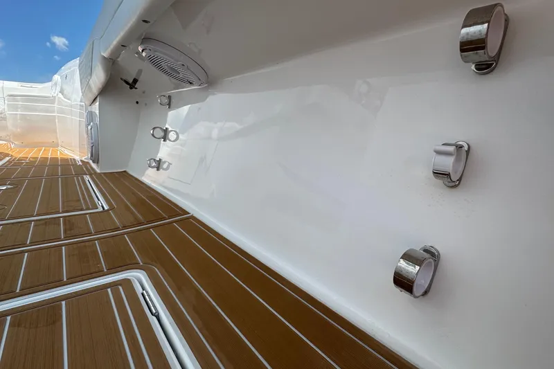 Slide: The Image of 2025 Intrepid 375 Nomad SE boat deck with teak flooring and stainless steel fixtures. - 22