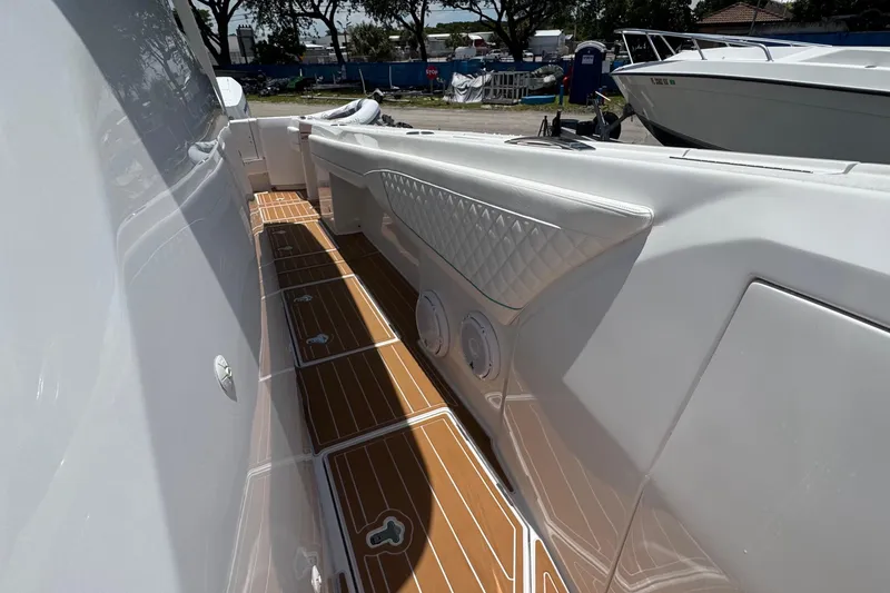 Slide: The Image of 2025 Intrepid 375 Nomad SE boat interior with sleek design and wood-patterned flooring. - 29