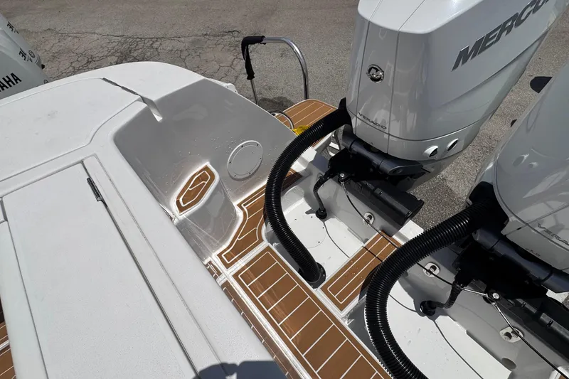 Slide: The Image of 2025 Intrepid 375 Nomad SE boat with dual Mercury outboard engines and teak-style decking. - 19